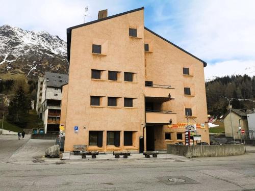 a large brick building with benches in front of it at Appartamento Claudia in San Bernardino