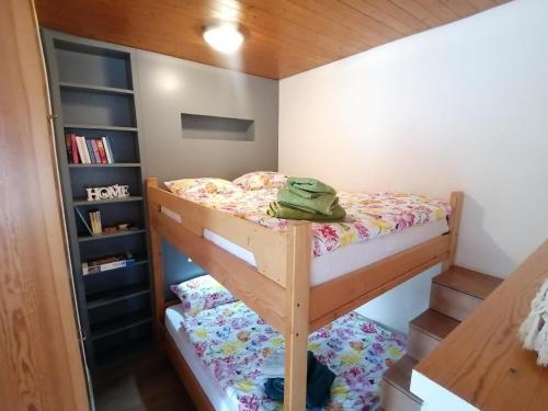 a bedroom with a bunk bed and a book shelf at Appartamento Claudia in San Bernardino