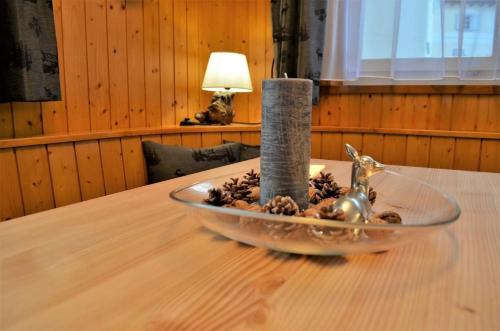 a glass bowl with a candle on a table at Chesa Talvo in Samedan