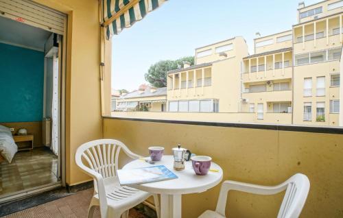 a small table and chairs on a balcony with a window at 2 Bedroom Lovely Apartment In Lavagna in Lavagna