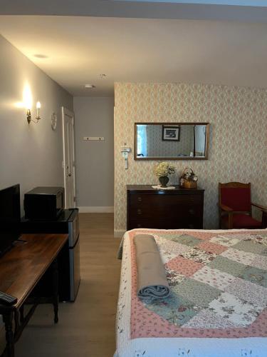a bedroom with a bed and a table and a desk at Old Orchard Beach Inn in Old Orchard Beach