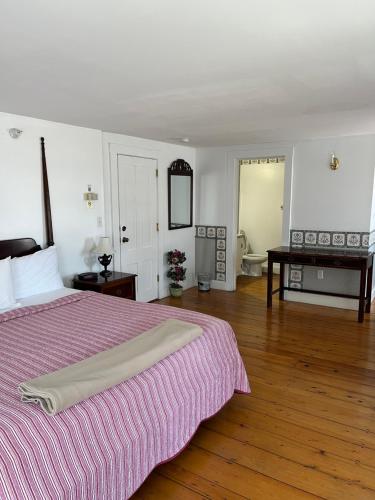 a bedroom with a large bed and a table at Old Orchard Beach Inn in Old Orchard Beach