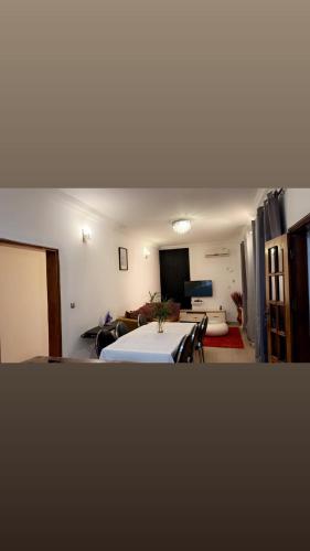 a room with a bed and a living room at Résidence Hôtelière l'Océane in Kribi
