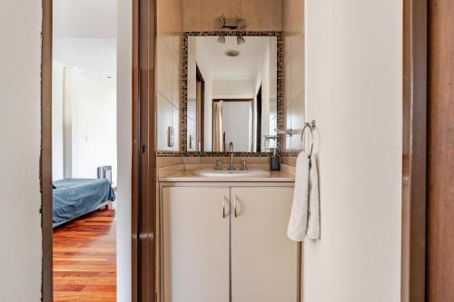 a bathroom with a sink and a mirror at Complejo Abaurrea in Mendoza