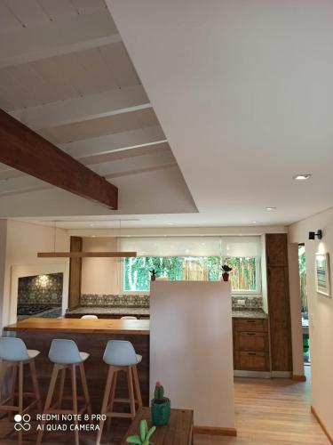 a kitchen with a table and stools in a room at Duplex Luna in Pinamar