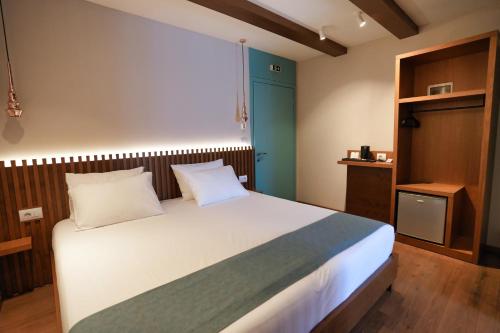 a bedroom with a large bed and a blue door at Palorto Traditional Hotel in Gjirokastër