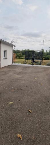 an empty parking lot with an airplane in the background at Studio plein Sud au calme in Montauban
