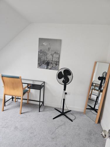 a room with a table and chairs and a mirror at Double Cosy Bedroom in Central Dartford in Dartford