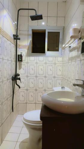 a bathroom with a sink and a toilet at Résidence Hôtelière l'Océane in Kribi
