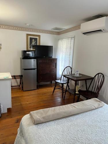 a room with a bed and a table with chairs at Old Orchard Beach Inn in Old Orchard Beach