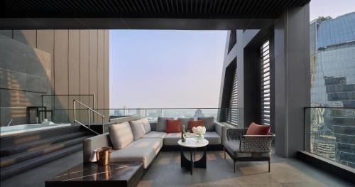 a living room with a couch and a table at InterContinental Bangkok Sukhumvit by IHG in Bangkok