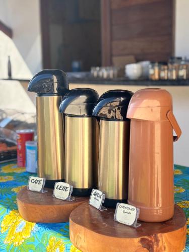 a group of kettles on a table with price tags at Morada das Dunas in Atins