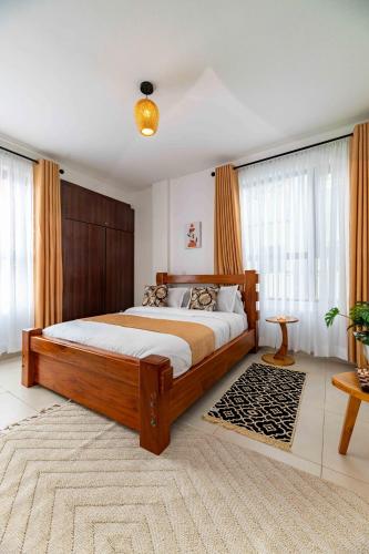 a bedroom with a large wooden bed in a room at Lorien Homes in Nairobi