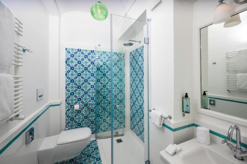 a bathroom with a shower and a toilet and a sink at Albergo California in Positano