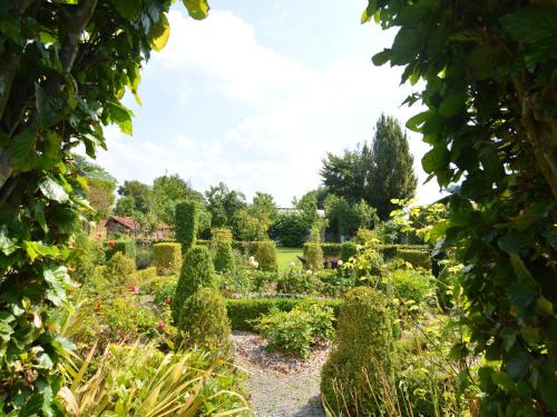 a view of a garden from a doorway at Comfortable Home with Sauna in Flobecq