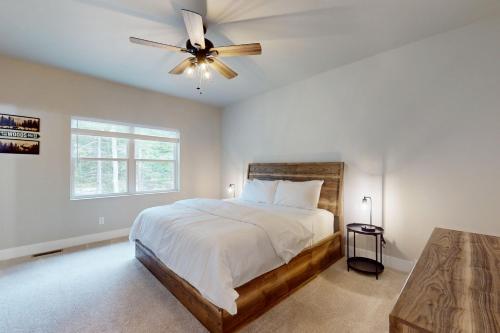 a bedroom with a bed and a ceiling fan at The Crossing at Lake Forest- 35 in Eagle River