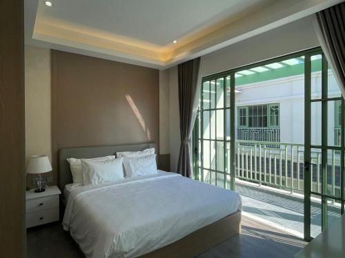 a bedroom with a large bed and a balcony at La isla Apartments & Villas - Sea View & Fireworks Phu Quoc in Phu Quoc