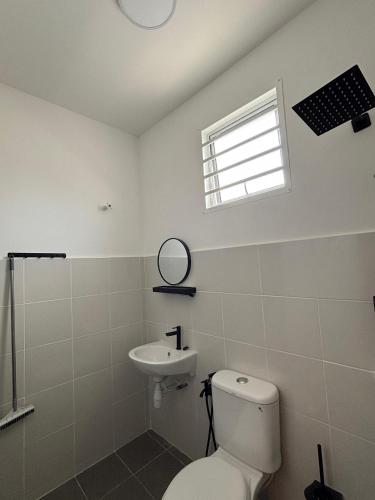 a bathroom with a toilet and a sink at Ris Homestay Islam FOREST HEIGHT in Seremban