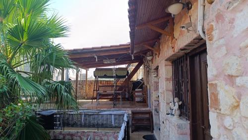 an outdoor patio with a table and a umbrella at Tryfonapartment school1922 in Krousón