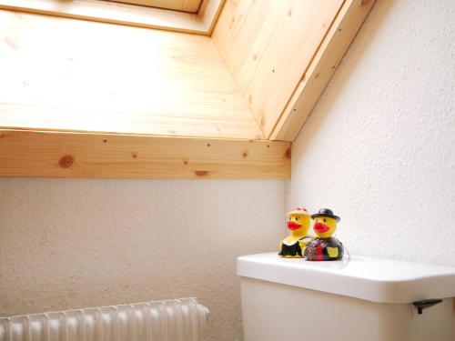 two rubber ducks sitting on top of a toilet in a bathroom at Haus Jurisch in Urberg