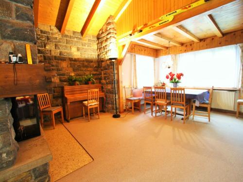 a dining room with a table and chairs at Bright Chalet with Terrace in Randogne