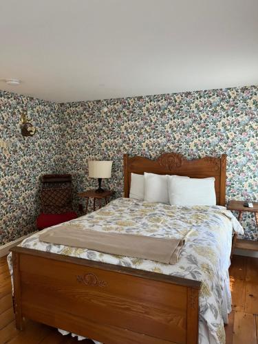 a bedroom with a large bed with floral wallpaper at Old Orchard Beach Inn in Old Orchard Beach