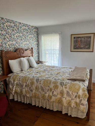 a bedroom with a large bed with a floral wallpaper at Old Orchard Beach Inn in Old Orchard Beach