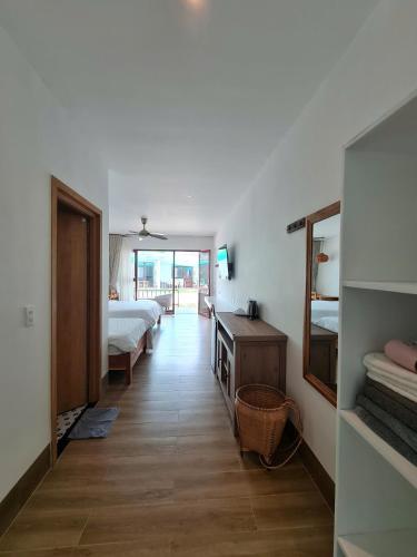 a room with a bed and a bedroom with a mirror at Myhoa Lagoon - Kiting Town in Phan Rang
