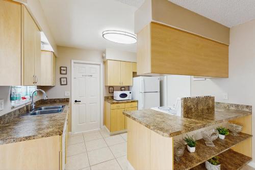 a large kitchen with wooden cabinets and a sink at Pool Access! Dog-Friendly Retreat 16 Mi to Orlando in Orlando