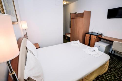 a hotel room with a bed and a desk at Visconti Militari in Bucharest