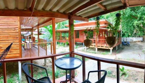 a view from the balcony of a house with plants at Wooden House Koh Lanta in Ko Lanta Yai