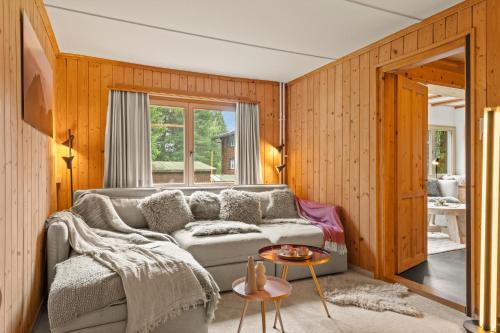 a living room with a couch and a window at A&Y Chalet Davos Central in Davos