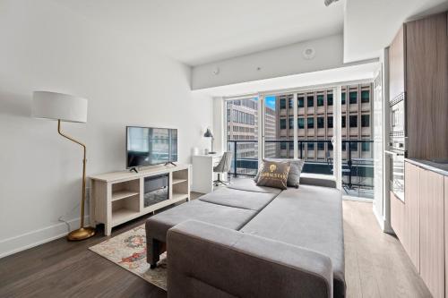 a living room with a couch and a tv at Modern 1BD Apartment with Balcony DT Toronto in Toronto