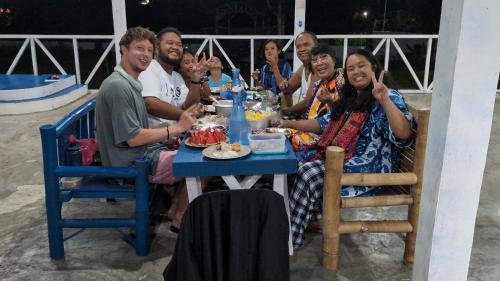 a group of people sitting at a table eating food at B'lu Bamboo in Moalboal