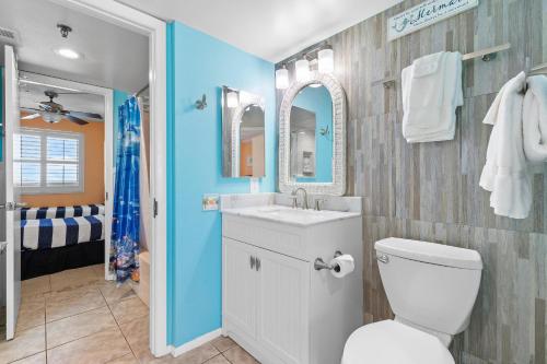 a bathroom with a white toilet and a sink at Oceania Plaza 808 in New Smyrna Beach