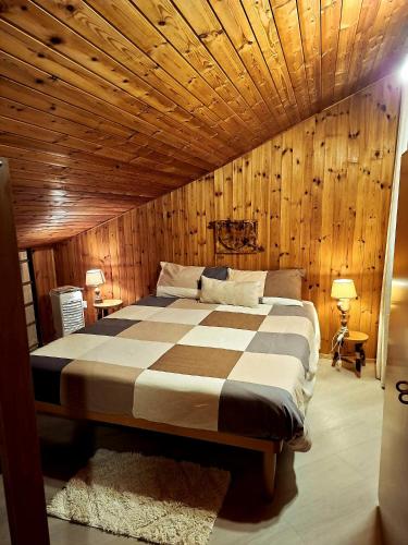 a bedroom with a bed with a wooden ceiling at Graziosa mansarda rustica - CIR VDA 0038 in Aosta