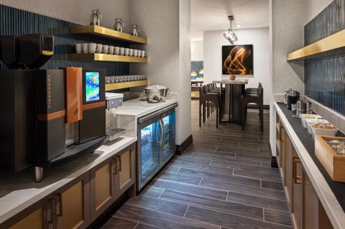 a kitchen with a counter with a dining room at Marriott Bloomington Normal Hotel and Conference Center in Bloomington