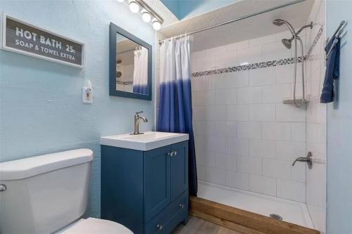 a bathroom with a toilet and a sink and a shower at Bombora Suites #202 | Flamingo Suite in Flagler Beach