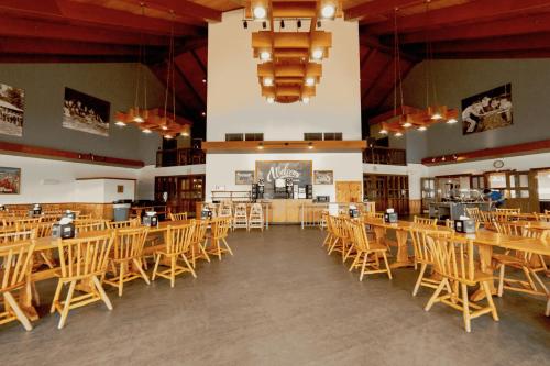 a large room with wooden tables and chairs at YMCA Trout Lodge in Potosi
