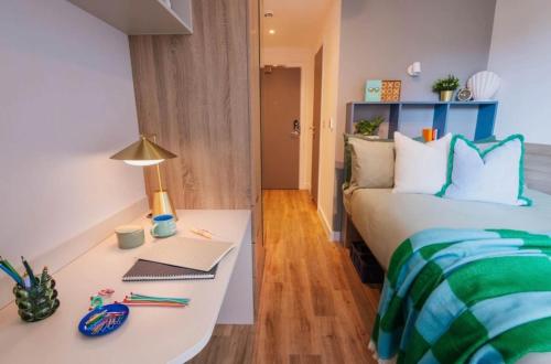 a bedroom with a bed and a desk with a laptop at Brand New Ensuite Rooms In Central Leeds in Leeds
