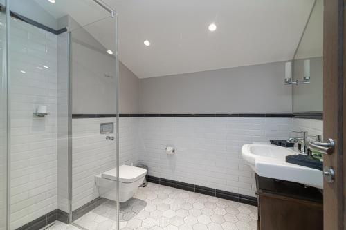 a bathroom with a toilet and a sink and a shower at Royal Horse Resort in Balkasodis