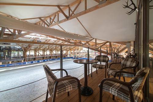 a row of chairs and a table in a train station at Royal Horse Resort in Balkasodis