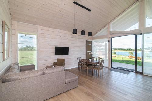 a living room with a couch and a table at Royal Horse Resort in Balkasodis