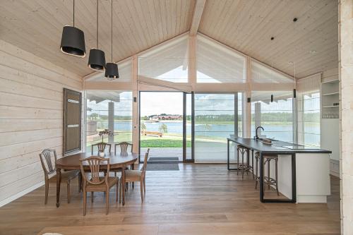 a kitchen and dining room with a table and chairs at Royal Horse Resort in Balkasodis