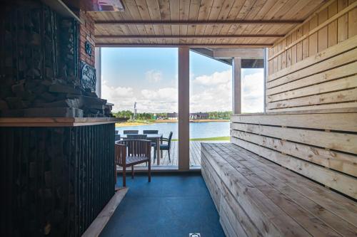 a view from the inside of a house with a view of the water at Royal Horse Resort in Balkasodis