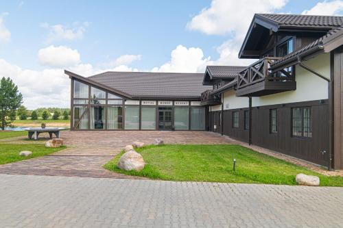 a house with a brick driveway in front of it at Royal Horse Resort in Balkasodis