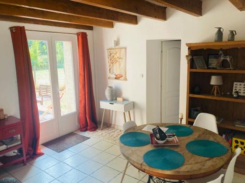 a dining room with a table and a window at Petite maison à la campagne in Saint-Germain
