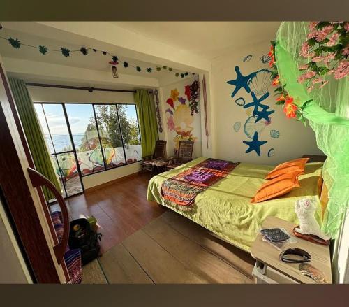 a bedroom with a bed and a large window at Jardín Andino Hostal in Copacabana