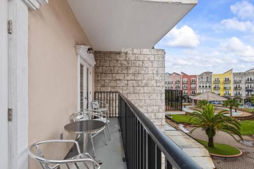 a balcony with a table and chairs and buildings at 301 Tuscan Breeze Getaway | Palm Coast in Palm Coast