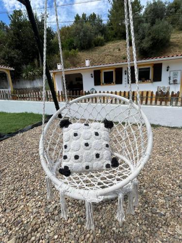a white swing in a yard with a house at DEl Rey Guest House in Tomar